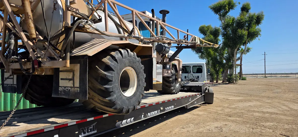 Ag-Chem sprayer loaded on Landoll flatbed trailer Bakersfield CA